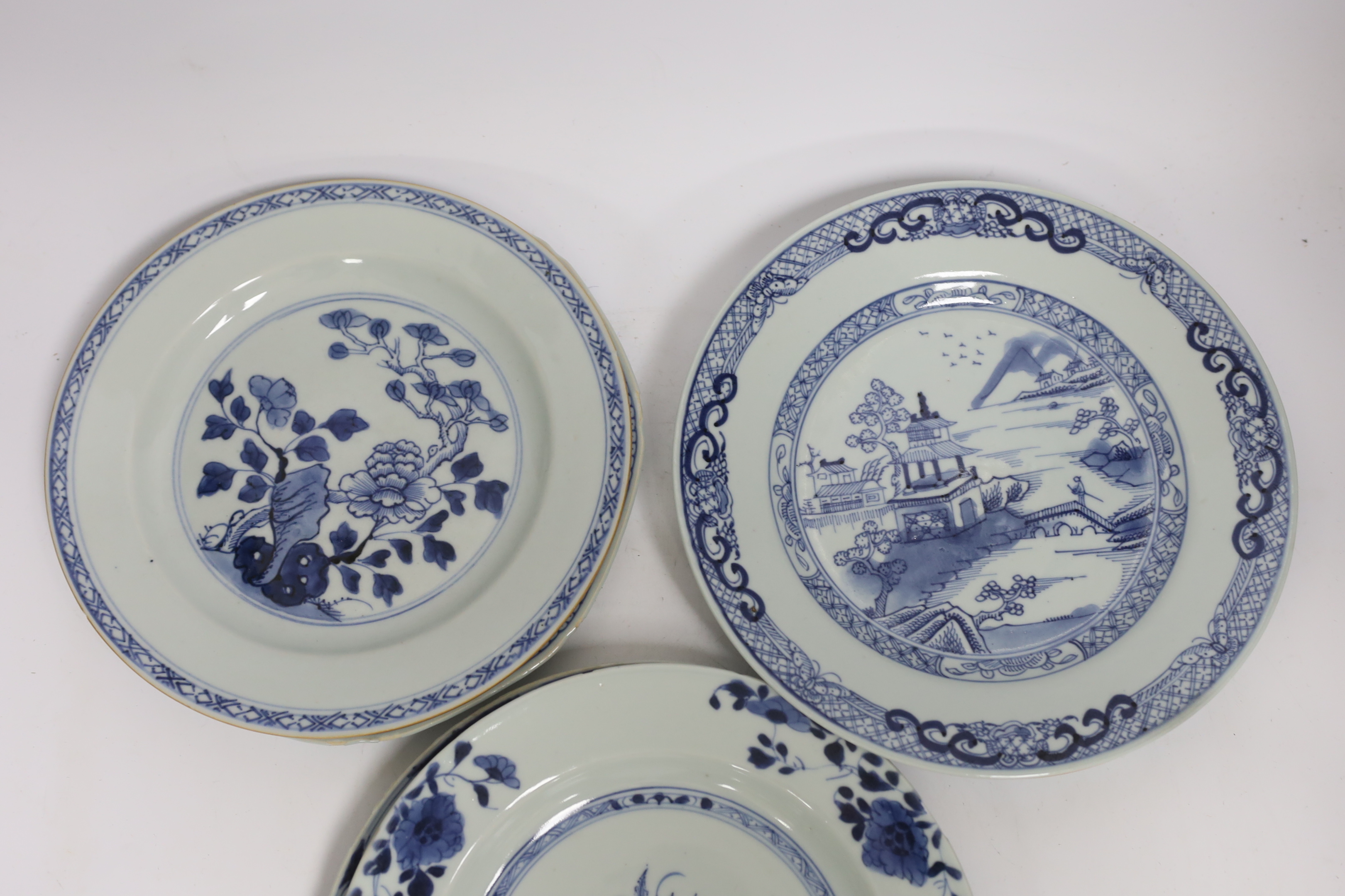 Six Chinese blue and white plates, 18th century and a Kangxi blue and white bowl and wood stand